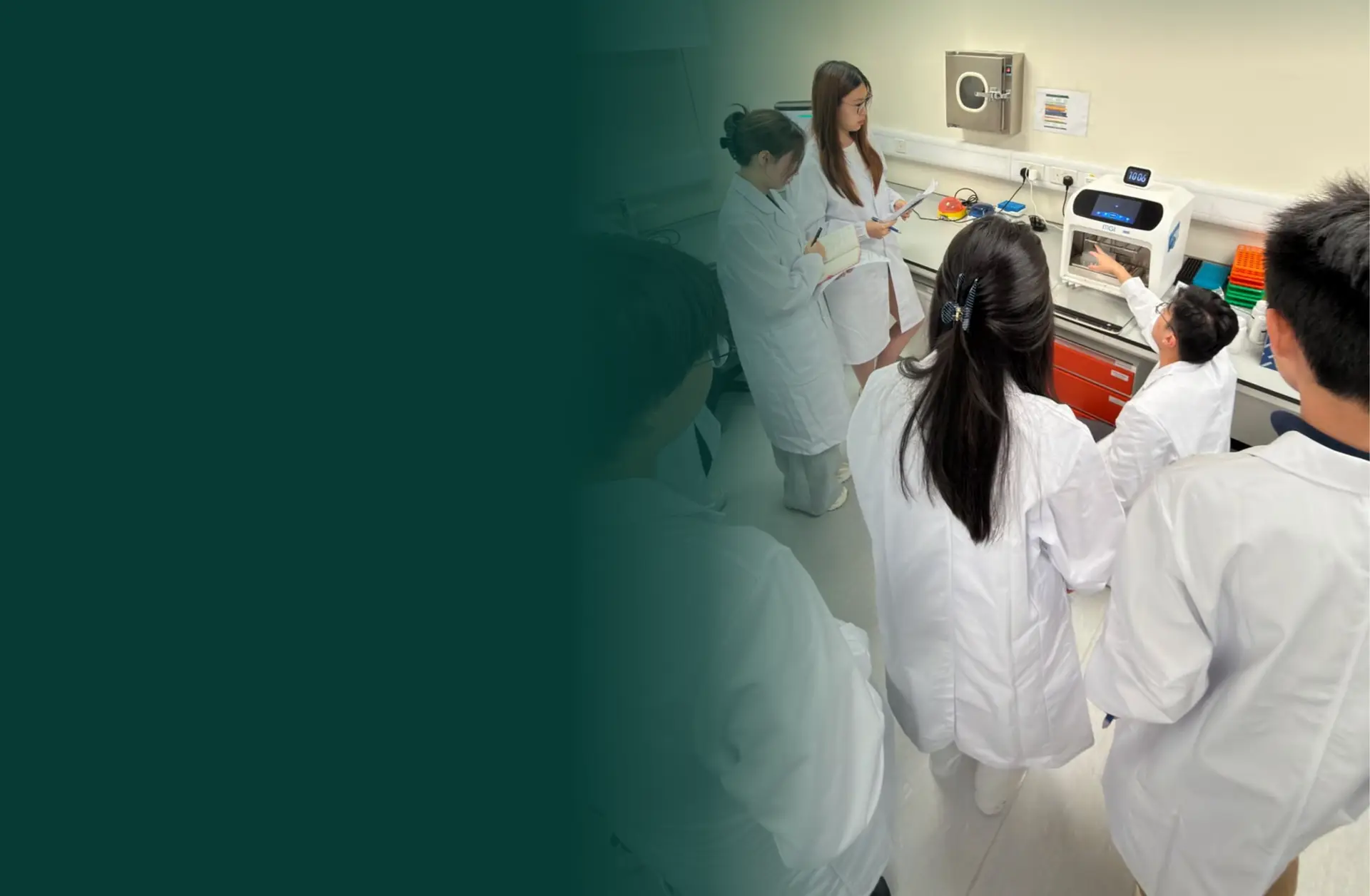 Students in lab coats watching a laboratory demonstration