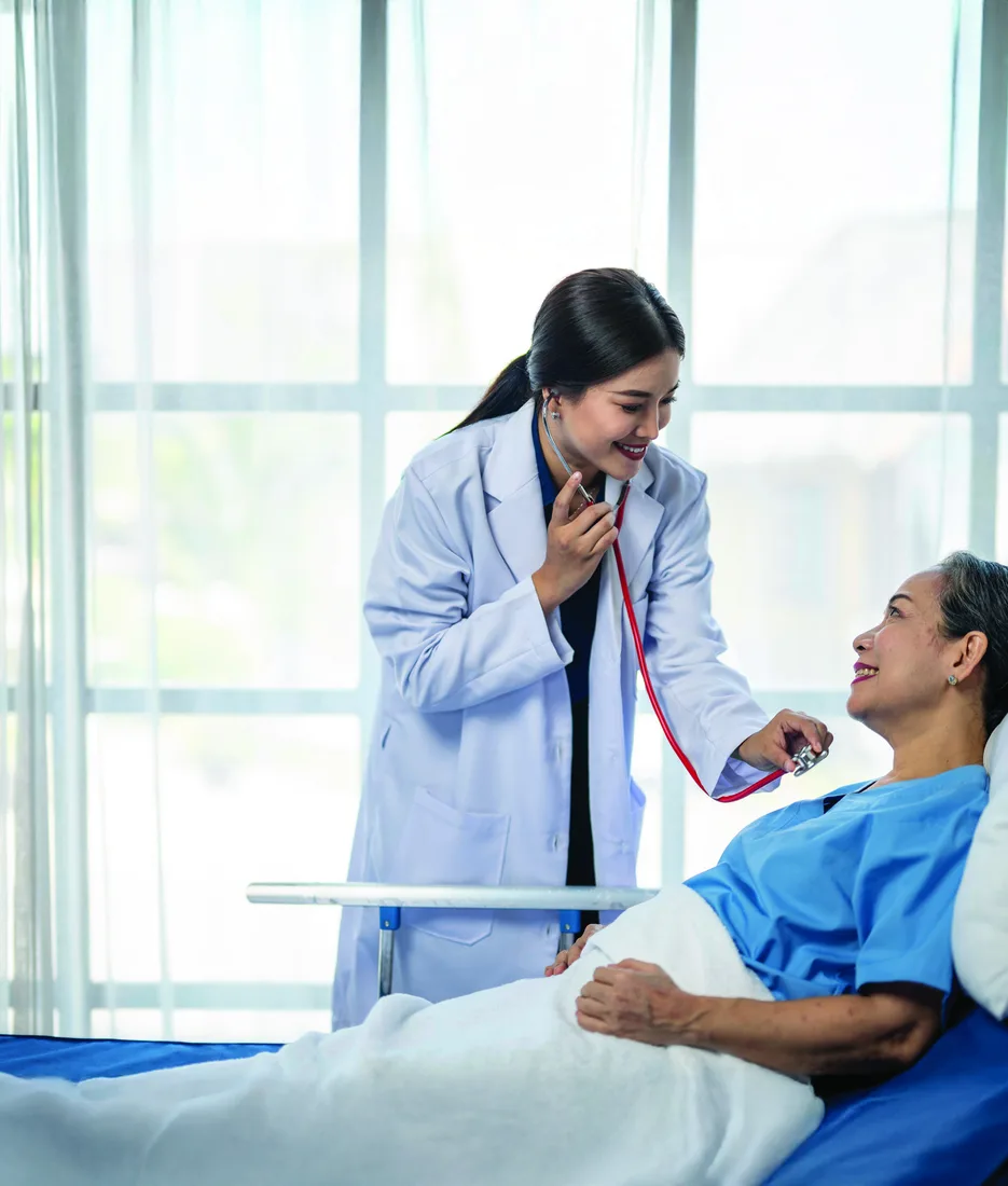 A doctor listening to a patient’s heartbeat